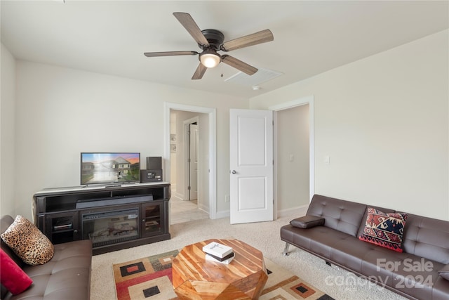 carpeted living room featuring ceiling fan