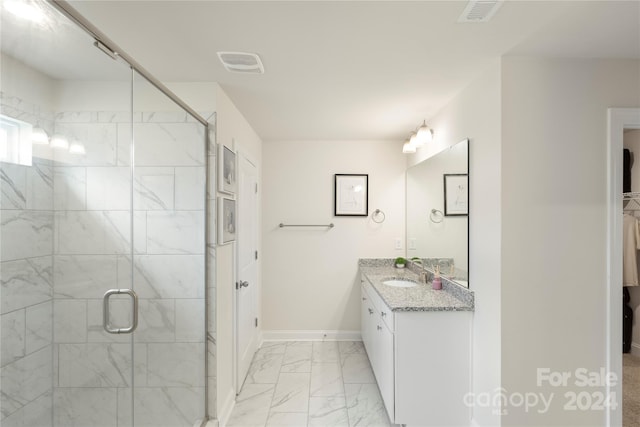 bathroom featuring vanity and a shower with shower door