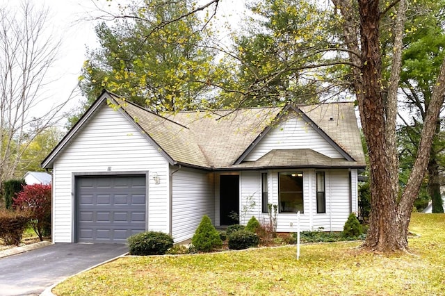 view of front of house featuring a front yard and a garage