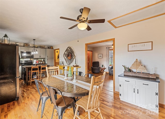 dining room with ceiling fan and light hardwood / wood-style floors