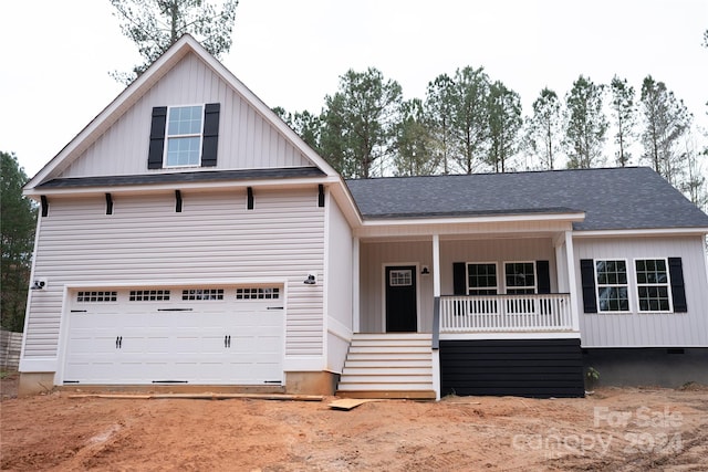 view of front of home featuring covered porch and a garage