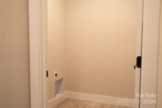 laundry room with light hardwood / wood-style flooring and electric dryer hookup