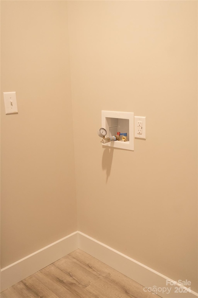 laundry area featuring hardwood / wood-style flooring and hookup for a washing machine