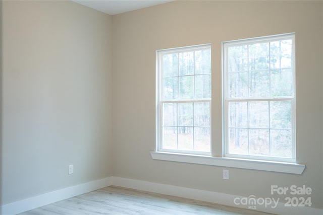 spare room with light hardwood / wood-style flooring