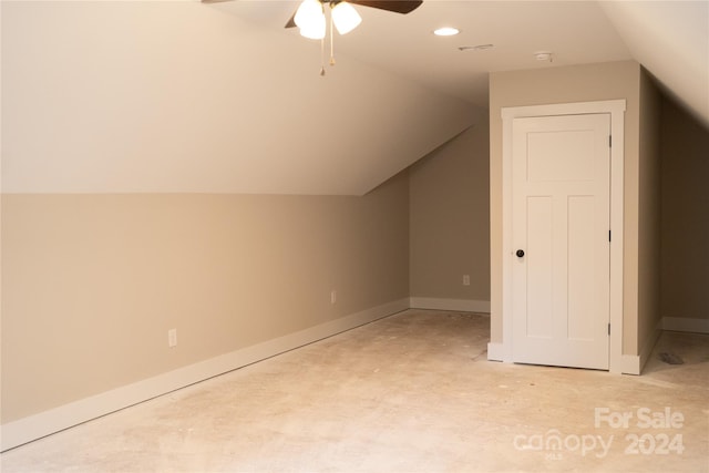 additional living space with ceiling fan, light colored carpet, and vaulted ceiling