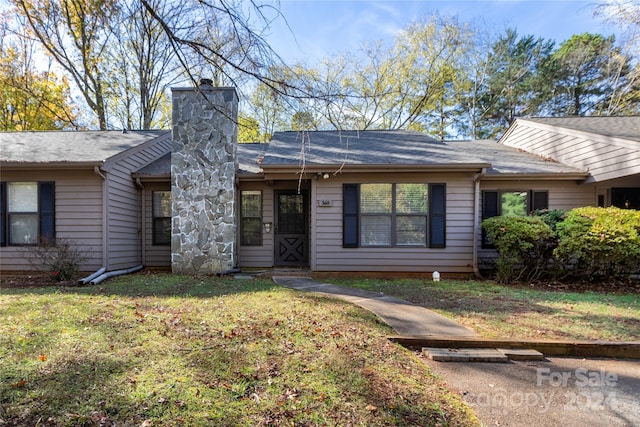 single story home featuring a front yard