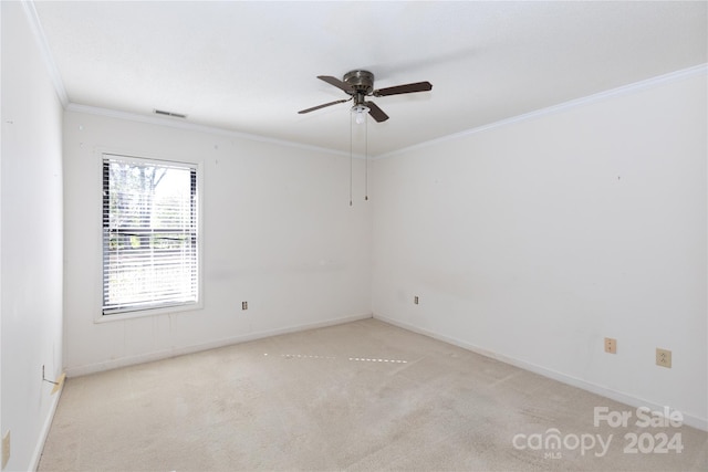 unfurnished room with light carpet, crown molding, and ceiling fan