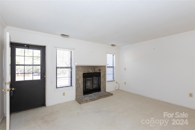 unfurnished living room with a stone fireplace, light carpet, and ornamental molding