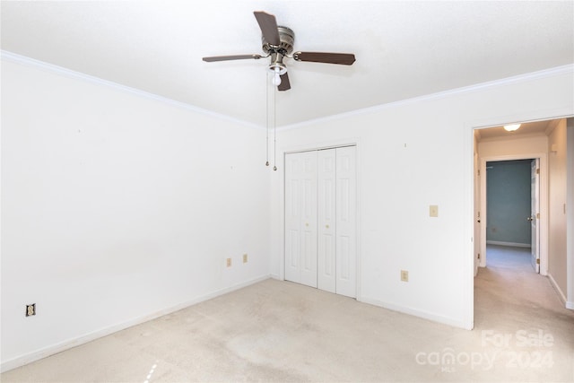 unfurnished bedroom featuring light carpet, ceiling fan, and ornamental molding