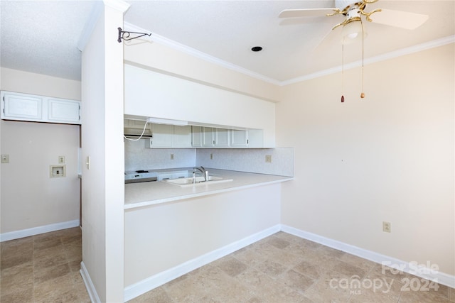 kitchen with backsplash, ceiling fan, white cabinetry, and ornamental molding