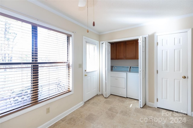 clothes washing area featuring cabinets, ornamental molding, a textured ceiling, ceiling fan, and independent washer and dryer