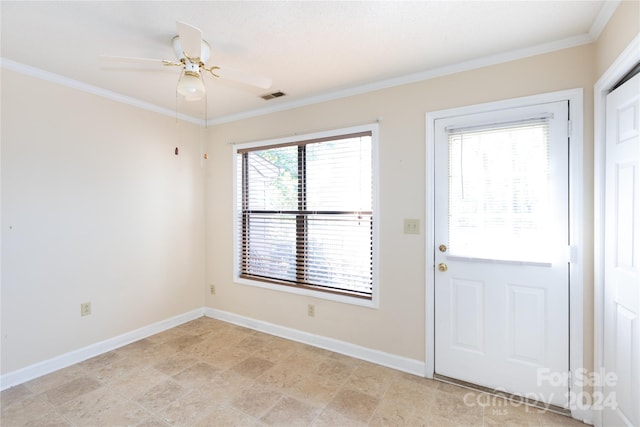 doorway featuring ceiling fan and crown molding