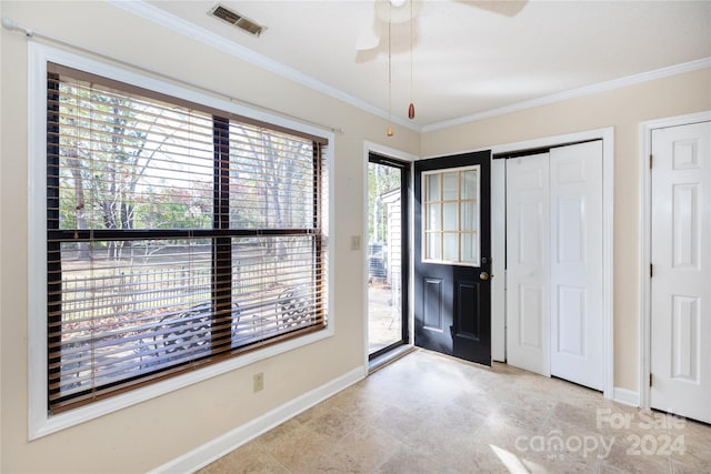 entryway featuring ceiling fan, a healthy amount of sunlight, and ornamental molding