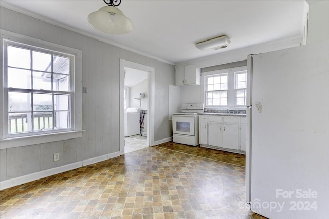 kitchen featuring white appliances, washer / clothes dryer, white cabinetry, and ornamental molding