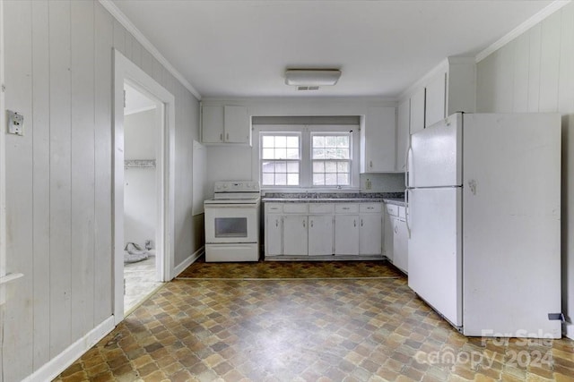 kitchen featuring white cabinets, ornamental molding, white appliances, and wooden walls