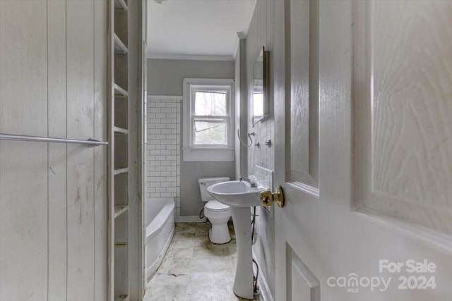 bathroom with a tub, crown molding, and toilet