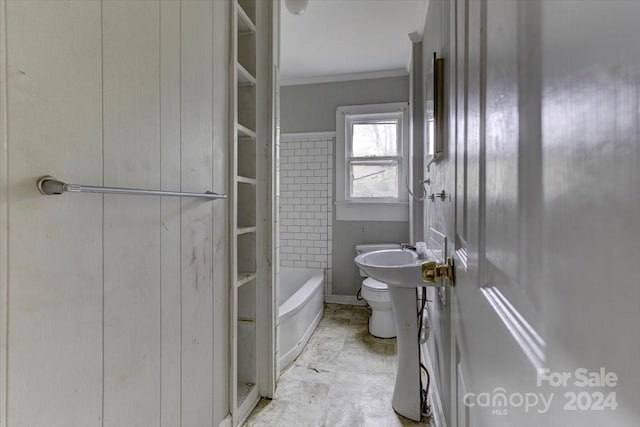 bathroom with a tub, crown molding, and toilet