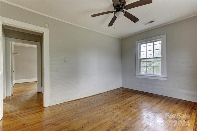 spare room with hardwood / wood-style flooring, ceiling fan, and crown molding