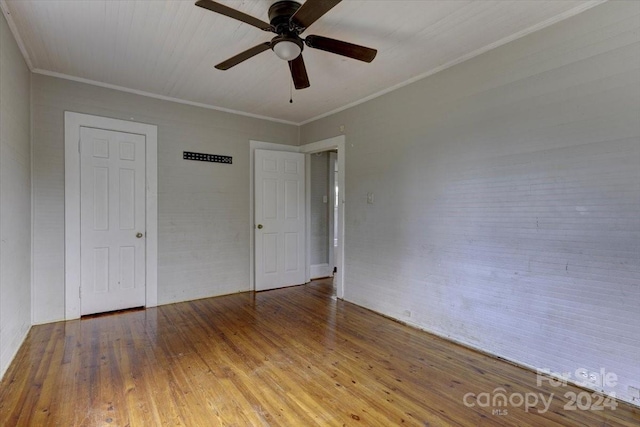 unfurnished bedroom with ceiling fan, ornamental molding, and hardwood / wood-style flooring