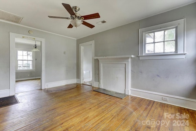 empty room with ceiling fan, crown molding, and light hardwood / wood-style floors