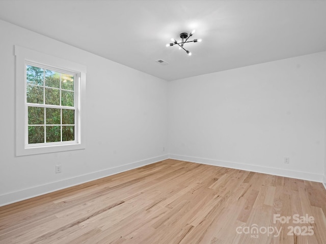 empty room with light hardwood / wood-style flooring