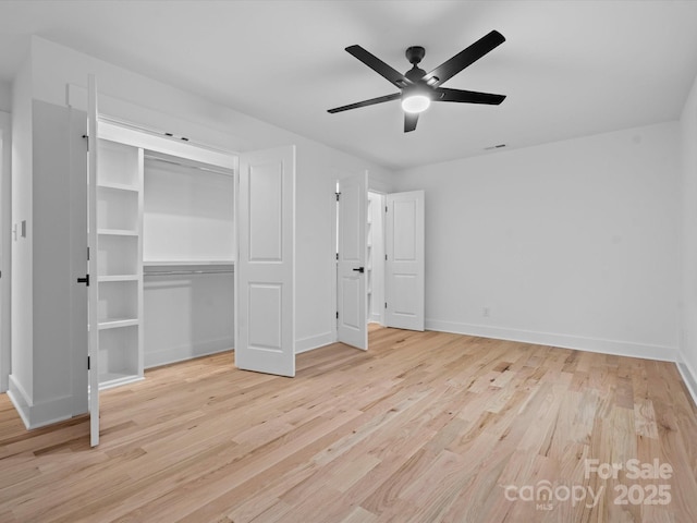 unfurnished bedroom with ceiling fan, a closet, and light hardwood / wood-style flooring