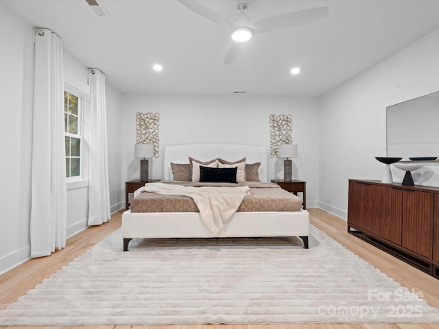 bedroom with light hardwood / wood-style floors and ceiling fan