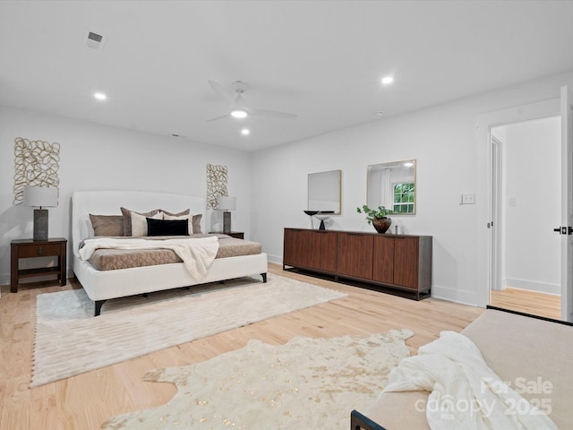 bedroom with light hardwood / wood-style floors and ceiling fan