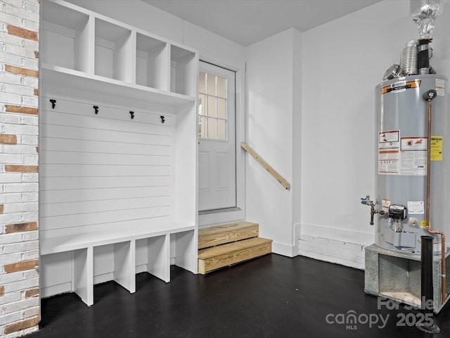 mudroom with brick wall and gas water heater