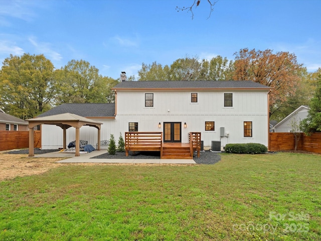 back of property featuring a gazebo, a yard, central AC, and a deck