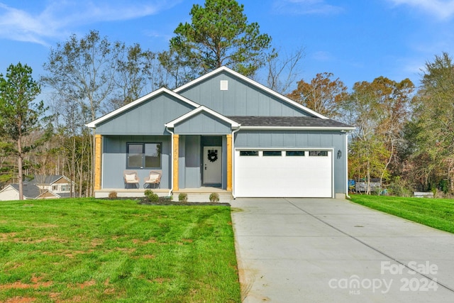 view of front of house with a porch, a garage, and a front yard