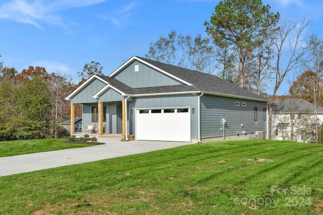 view of front facade featuring a porch, cooling unit, a garage, and a front yard