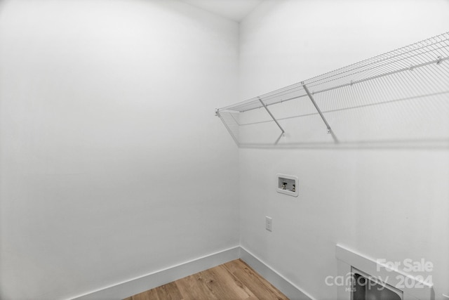 laundry area featuring hardwood / wood-style floors and washer hookup