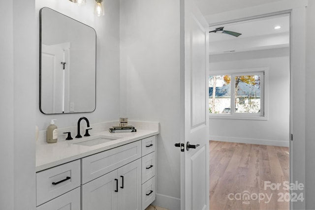 bathroom featuring vanity, hardwood / wood-style flooring, and ceiling fan