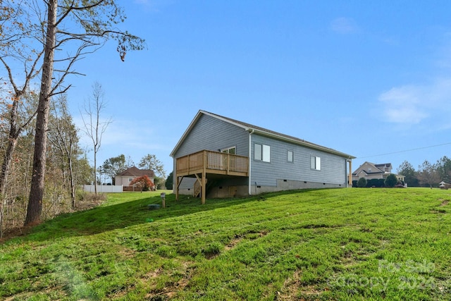 view of home's exterior featuring a lawn and a deck