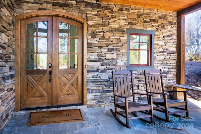 view of exterior entry featuring french doors