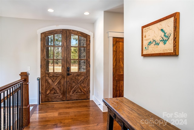 foyer with dark hardwood / wood-style flooring and french doors