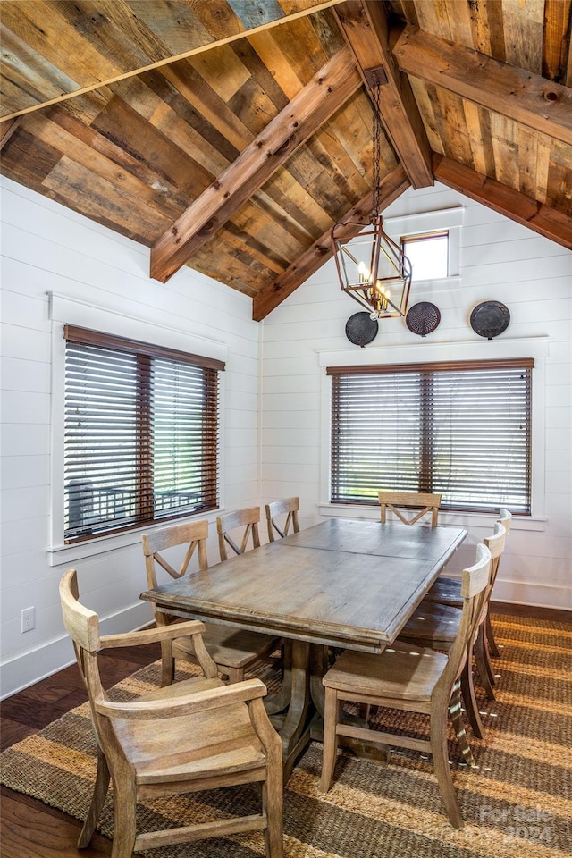 dining room featuring hardwood / wood-style flooring, plenty of natural light, lofted ceiling with beams, and an inviting chandelier