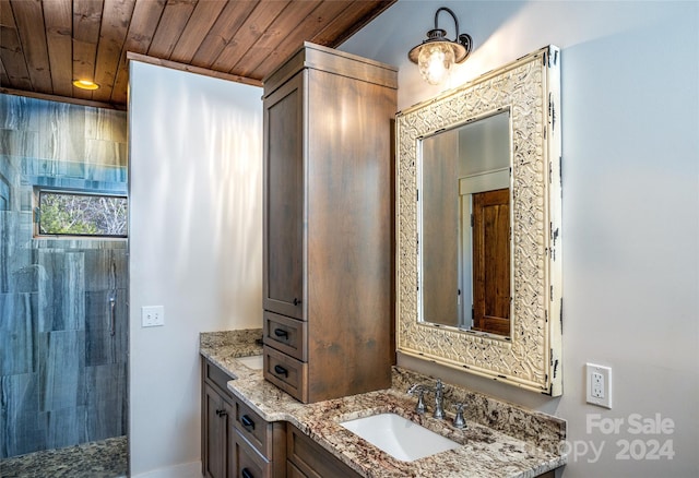 bathroom featuring a shower, vanity, and wooden ceiling