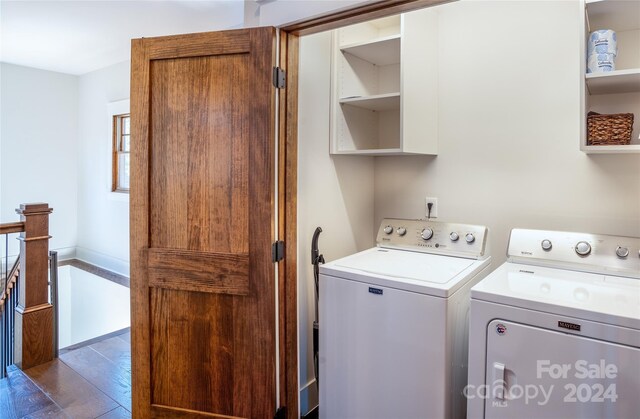 laundry room with washer and dryer and dark hardwood / wood-style floors