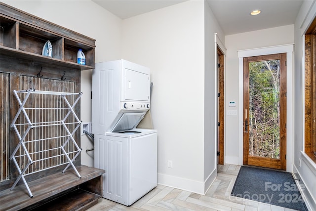 clothes washing area featuring stacked washer / dryer