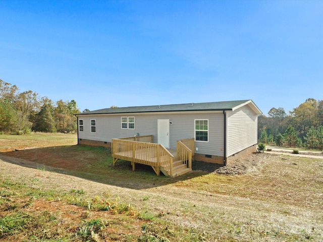 back of house featuring a wooden deck