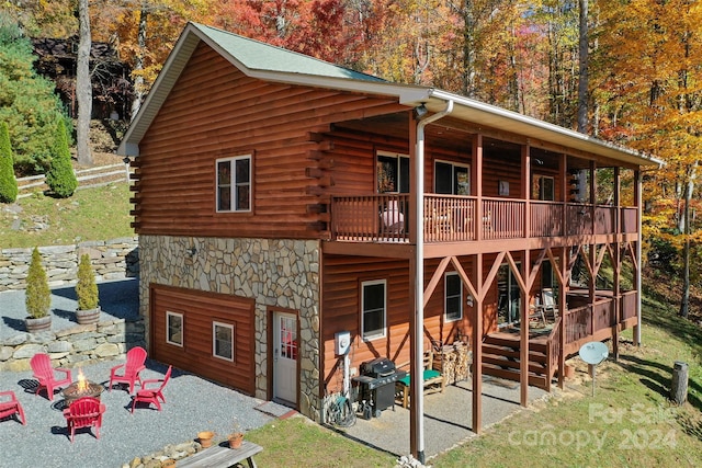 rear view of house featuring a deck