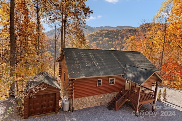 exterior space with a mountain view, an outbuilding, and a garage