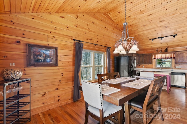 dining area with wooden ceiling, high vaulted ceiling, a notable chandelier, wooden walls, and light wood-type flooring