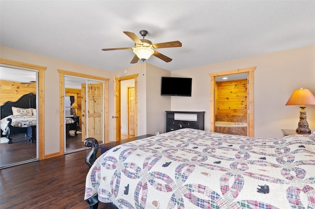 bedroom featuring dark hardwood / wood-style flooring, ceiling fan, and multiple closets