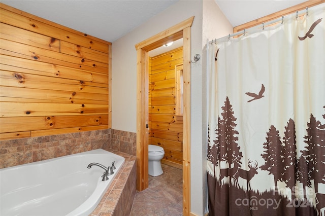 bathroom featuring toilet and tiled tub