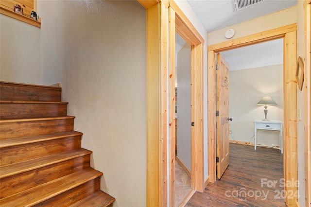 stairway featuring hardwood / wood-style floors