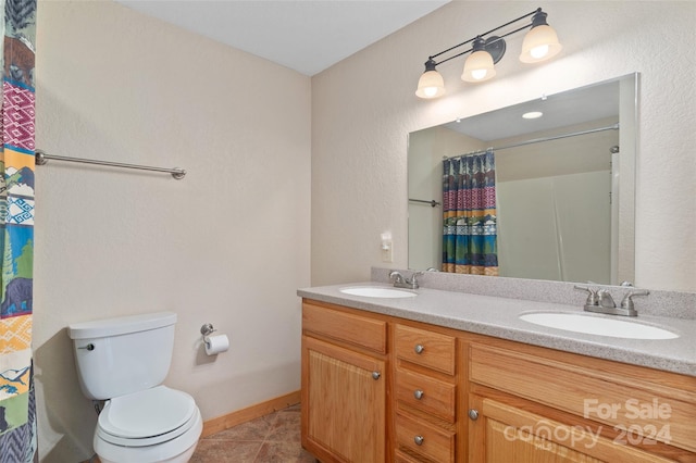 bathroom with curtained shower, tile patterned flooring, vanity, and toilet