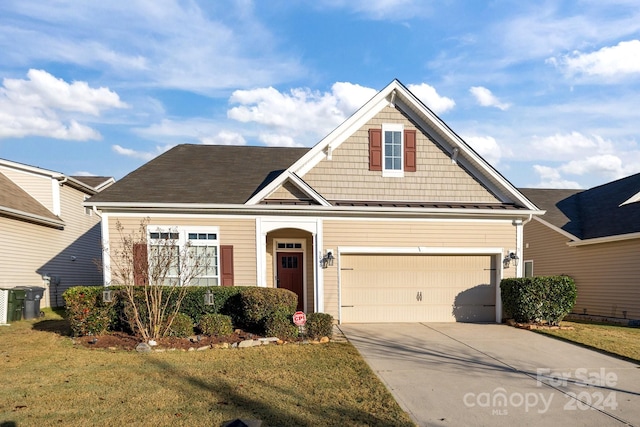 craftsman-style home with a front lawn and a garage